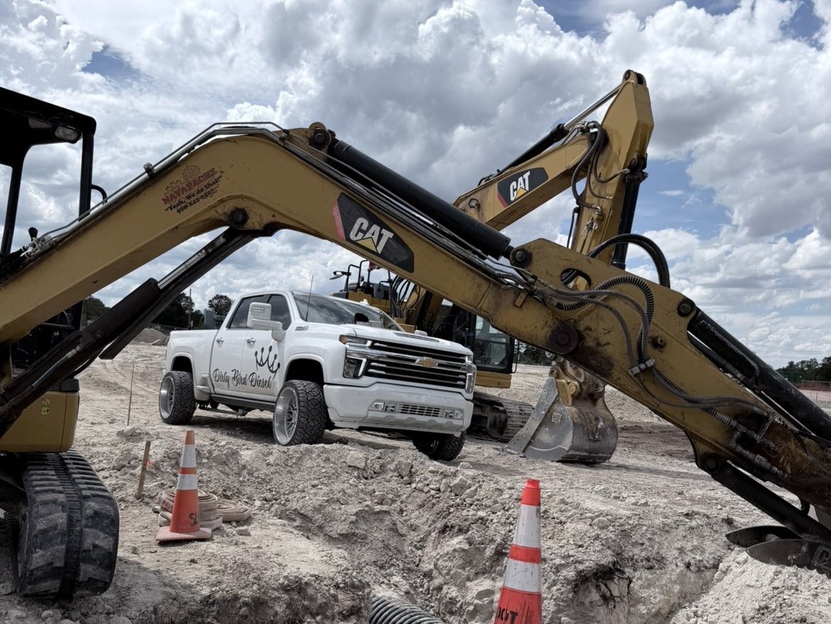 Dirty Bird Diesel truck working between CAT excavators on a job site